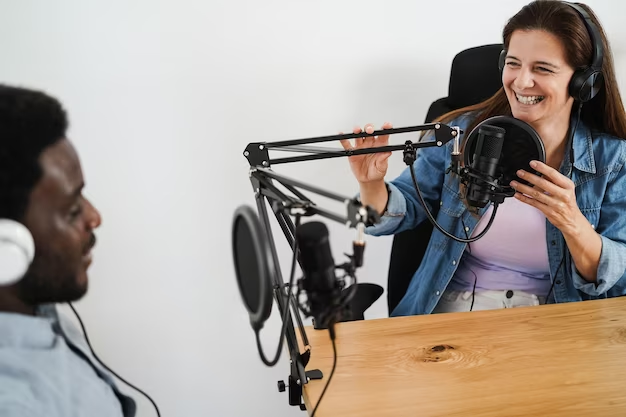 Two people chatting in a recording studio